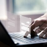 hand-using-laptop-computer-with-virtual-screen-document-online-approve-paperless-quality-assurance-erp-management-concept-1-scaled